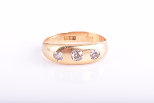 Lot 110 - A three-stone diamond ring; the slightly...