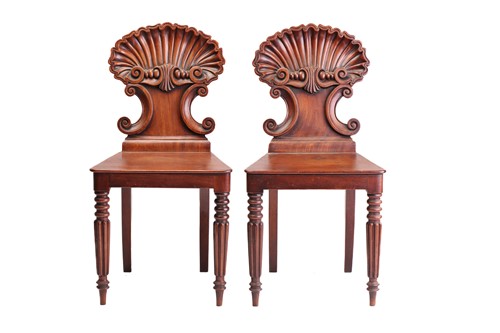 Lot 305 - A pair of George IV mahogany shell backed hall...