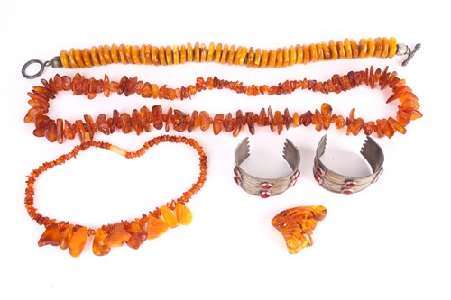 Lot 19 - A lot consists of three amber bead necklaces,...