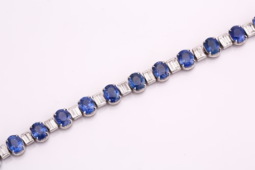 Lot 228 - A sapphire and diamond tennis bracelet,...