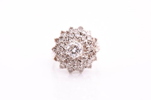 Lot 28 - A diamond cluster dress ring; the four tiers...