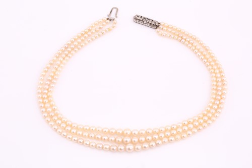 Lot 98 - A three-row cultured pearls necklace with an...