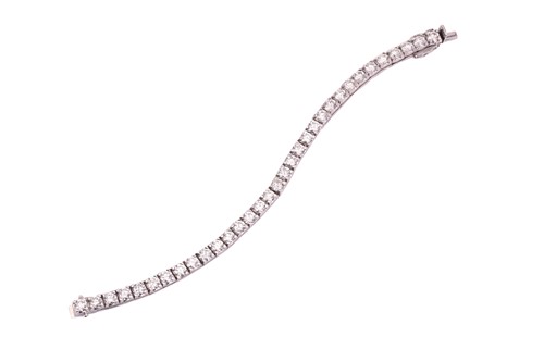 Lot 34 - A diamond tennis bracelet, set with...