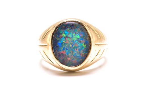 Lot 187 - An opal triplet ring, comprises an oval...