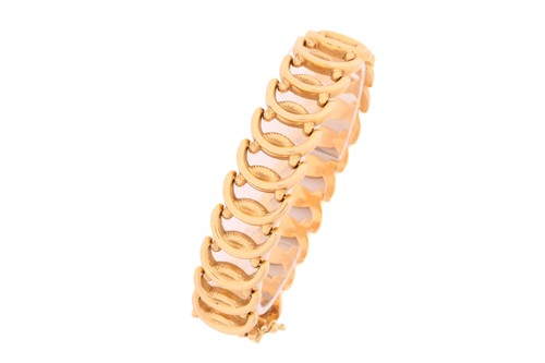 Lot 178 - A wide fancy link bracelet, with textured oval...
