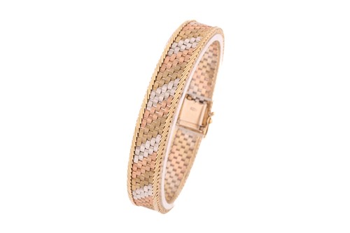 Lot 153 - A 9ct three-tone gold brick link bracelet,...
