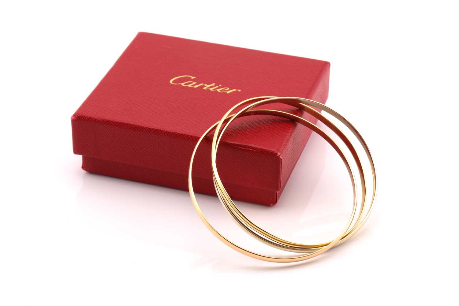 Lot 33 - A Cartier trinity bracelet, featuring three...