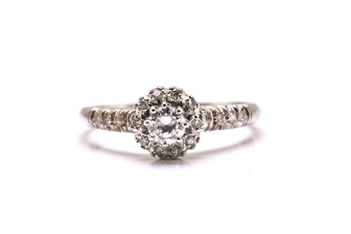 Lot 33 - A diamond entourage ring in white precious...