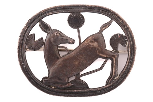 Lot 111 - Georg Jensen - a brooch depicting kneeling...