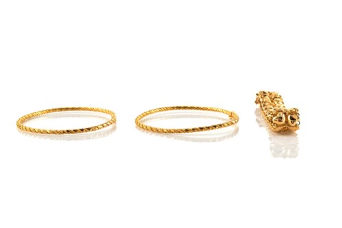 Lot 148 - A pair of tension bangles and a Poh Heng...