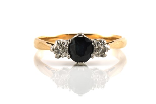 Lot 237 - A three-stone sapphire and diamond ring, with...