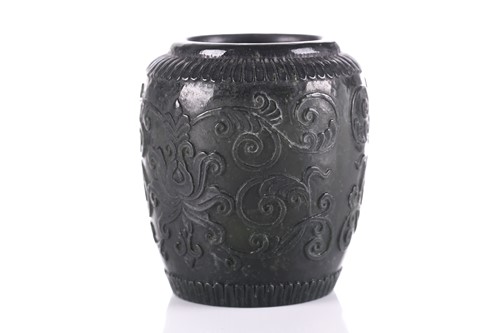 Lot 196 - A spinach jade jar, carved in relief with...
