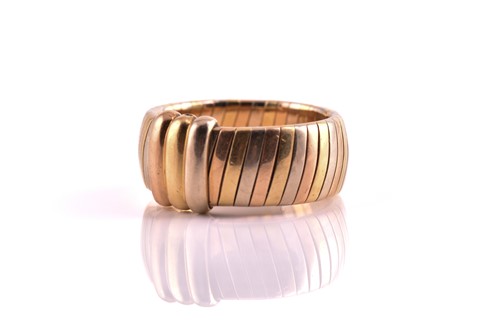 Lot 134 - Cartier - Tri-coloured tubogas band ring, with...