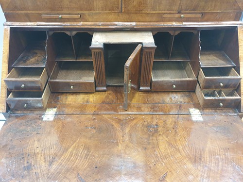Lot 131 - A George I walnut bureau bookcase the upper...