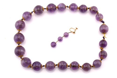 Lot 266 - An amethyst bead necklace and a similar single...