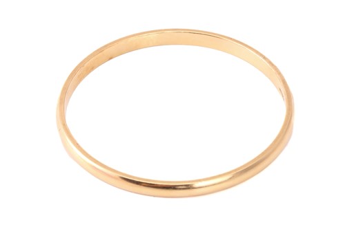 Lot 218 - A yellow precious metal closed bangle, with a...