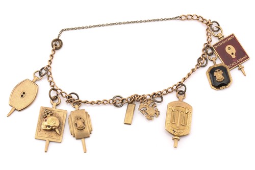 Lot 86 - A yellow metal bracelet with assorted college...