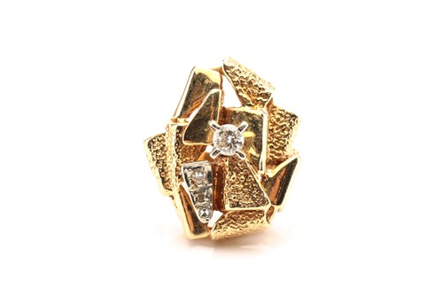 Lot 78 - A modernist yellow metal and diamond ring,...