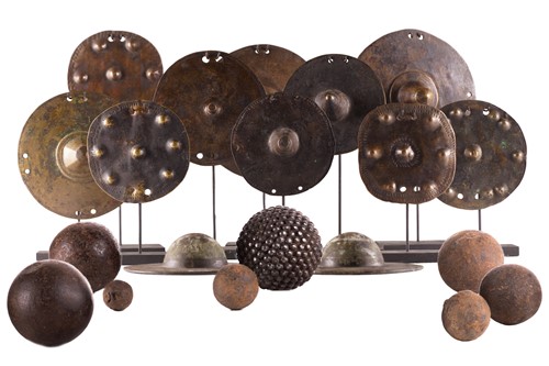 Lot 184 - A collection of twelve bronze shield bosses,...