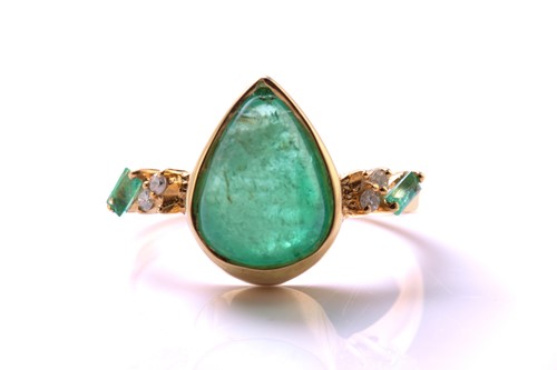Lot 79 - An emerald and diamond 18ct gold ring, centred...