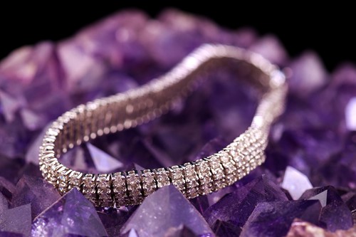 Lot 19 - A three-row diamond tennis bracelet, featuring...