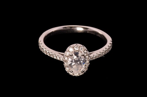 Lot 122 - An oval diamond entourage ring in 18ct gold,...