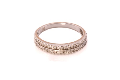 Lot 180 - A double row diamond ring in 18ct white gold,...