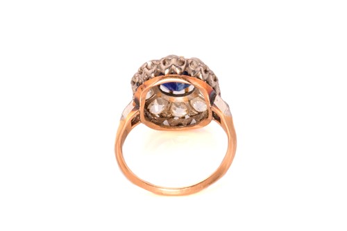 Lot 39 - A sapphire and diamond halo ring, comprises a...