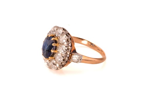 Lot 39 - A sapphire and diamond halo ring, comprises a...