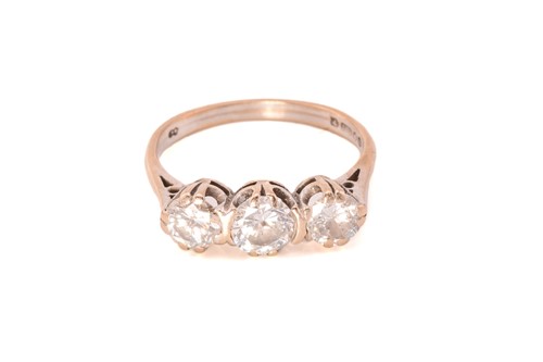 Lot 226 - A three-stone diamond ring in 18ct gold,...
