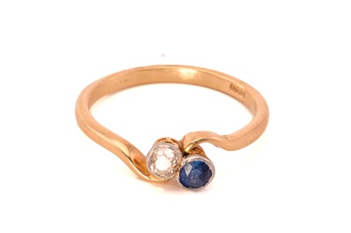 Lot 130 - A sapphire and diamond crossover ring, with a...