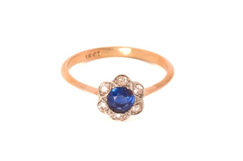 Lot 243 - A sapphire and diamond flower head ring,...