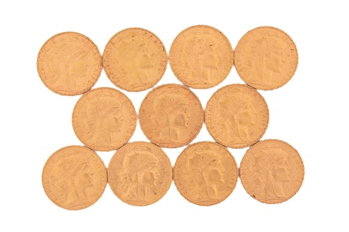 Lot 276 - Eleven 20 French Franc gold coins, with a...