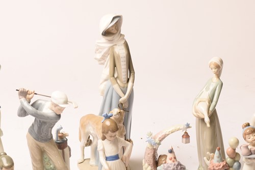 Lot 228 - A large collection of Lladro and Nao figurines,...