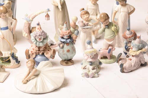 Lot 228 - A large collection of Lladro and Nao figurines,...