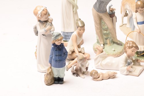 Lot 228 - A large collection of Lladro and Nao figurines,...