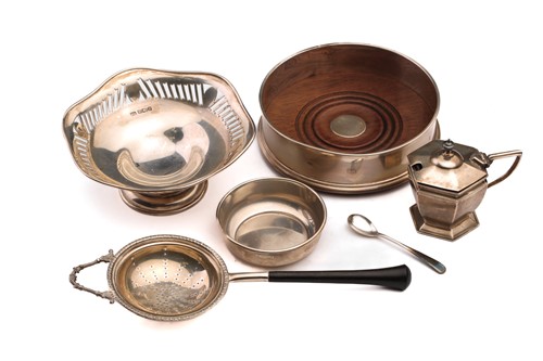 Lot 466 - A silver wine coaster with turned wooden base,...
