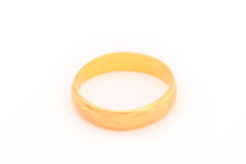 Lot 205 - A 22ct gold wedding band, Birmingham...