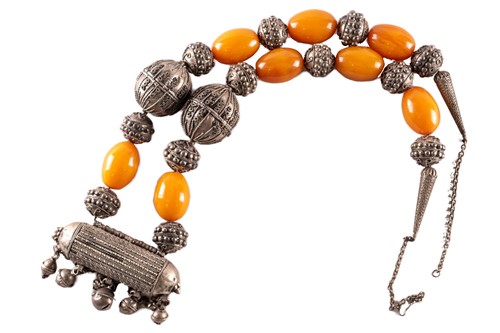 Lot 105 - A large Yemeni silver metal and amber necklace,...