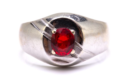 Lot 22 - A signet ring set with synthetic ruby,...