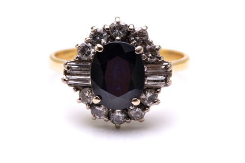 Lot 33 - A sapphire and diamond cluster ring in 18ct...