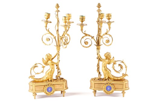 Lot 293 - A pair of Louis XVI style ormolu three-sconce...