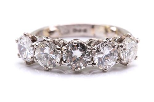 Lot 90 - A five-stone diamond ring in platinum,...