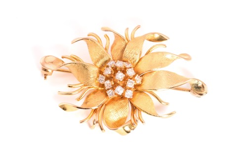 Lot 124 - A floral brooch, depicting a flower head with...