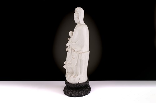 Lot 134 - A Chinese Dehua blanc de chine figure of...
