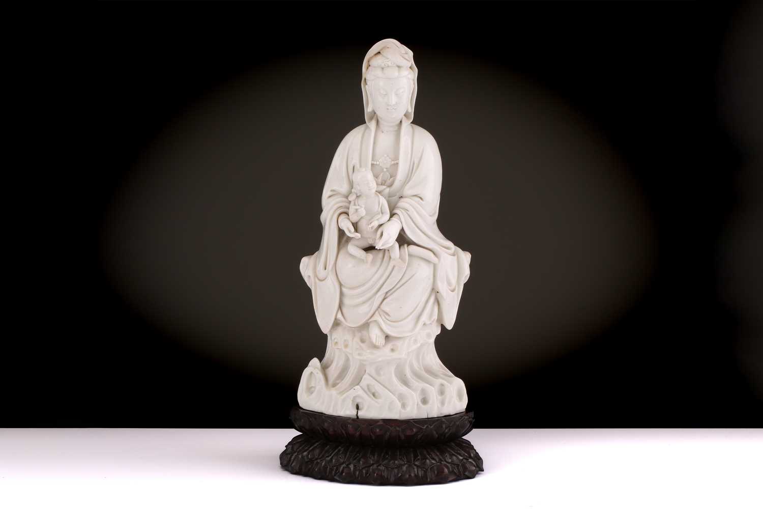Lot 134 - A Chinese Dehua blanc de chine figure of...