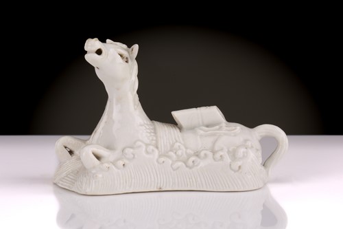 Lot 193 - A Chinese Dehua blanc de chine white horse of...
