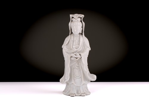 Lot 138 - A Chinese Dehua blanc de chine standing figure...