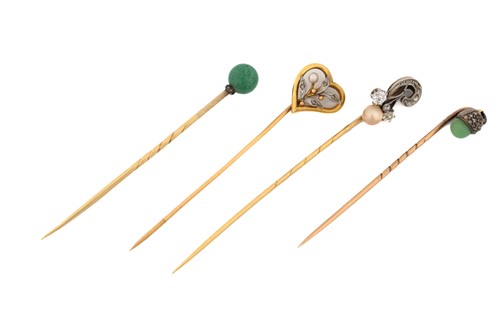 Lot 27 - Four gem-set stick pins; A heart-shaped stick...