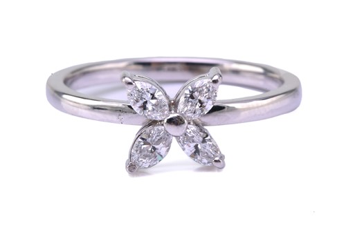 Lot 127 - A four-stone diamond petal ring, consisting of...